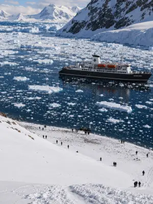 Aerial view of Terra Nova Adventurer anchored off a penguin colony