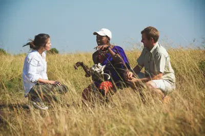 Maasai guide sharing bush lore on a walk