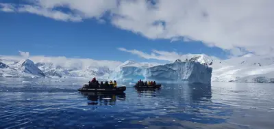 Zodiac cruising among icebergs