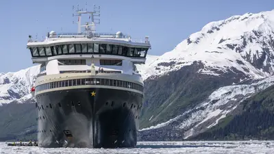 MS Roald Amundsen bow-on in an icy fjord