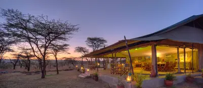Main lounge tent lit up at dusk