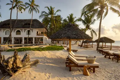 Beachfront building and sun loungers
