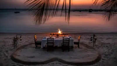 Candlelit beach dinner at sunset
