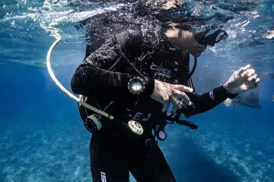 Diver checking kit underwater