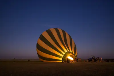 Hot-air balloon inflating before dawn