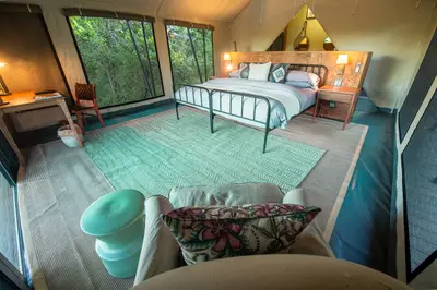 Luxury tent interior with river-facing windows