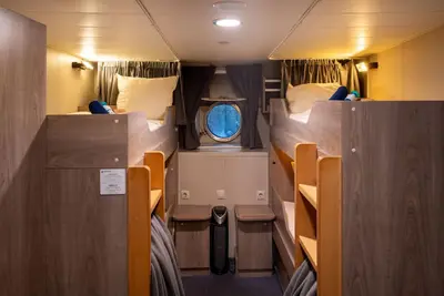 Quadruple Porthole cabin — upper and lower berths