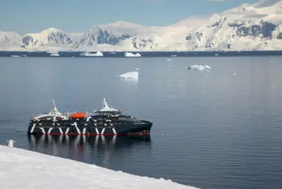 Magellan Explorer at anchor below Antarctic glaciers