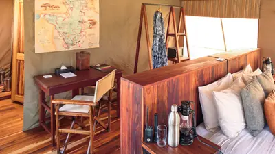 Writing desk and bed inside the guest tent