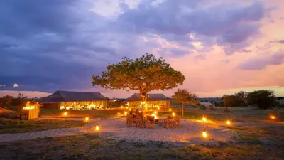 Camp lit by lanterns after dark