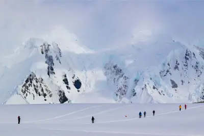 Guests trekking across a snowfield