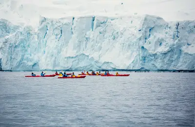 Sea kayaking beneath a glacier front