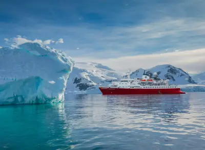 The same ship as G Expedition beside an iceberg (previous livery)